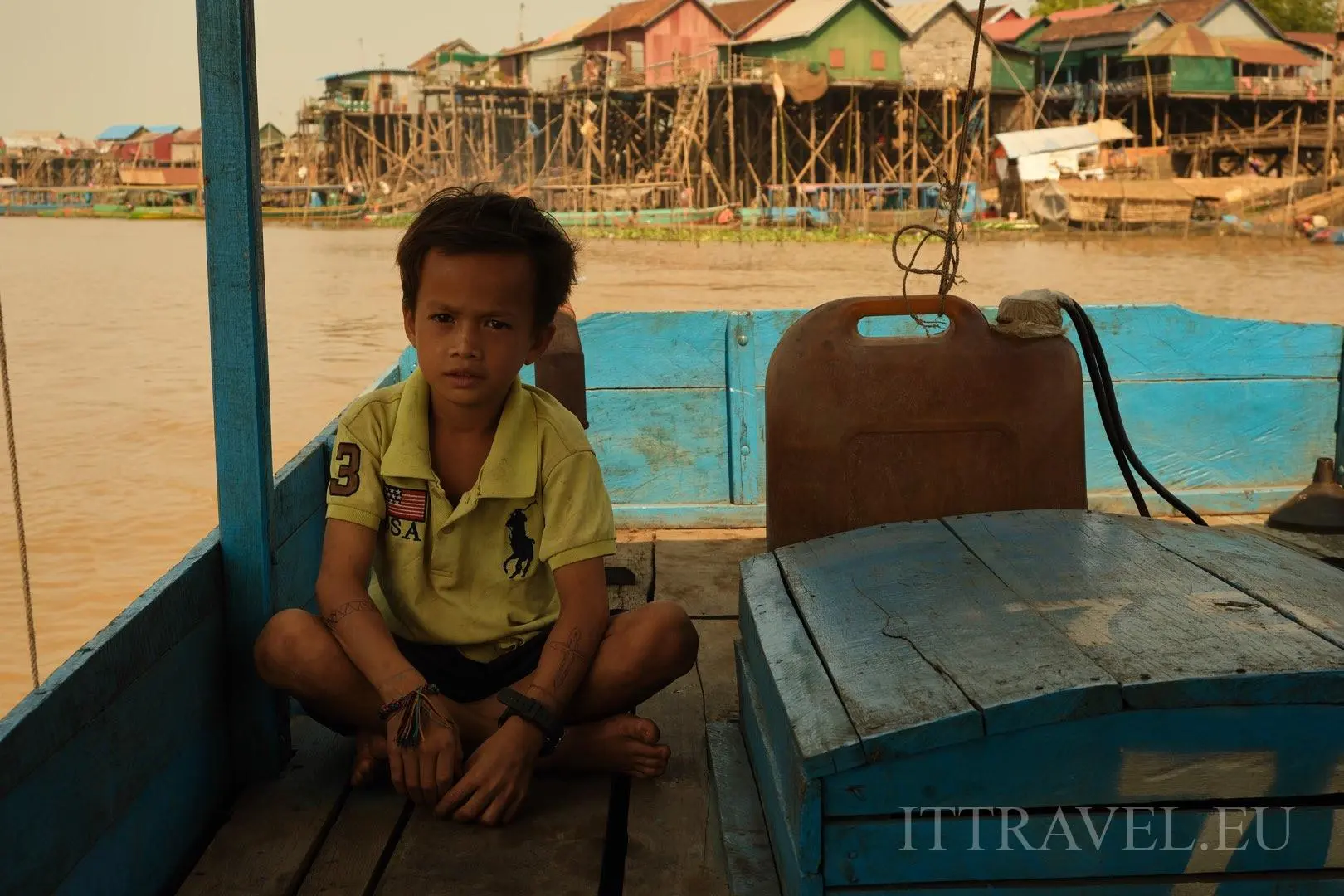 Boy that is helping his father on tourist boat